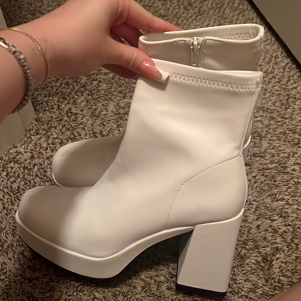 High heeled white boots